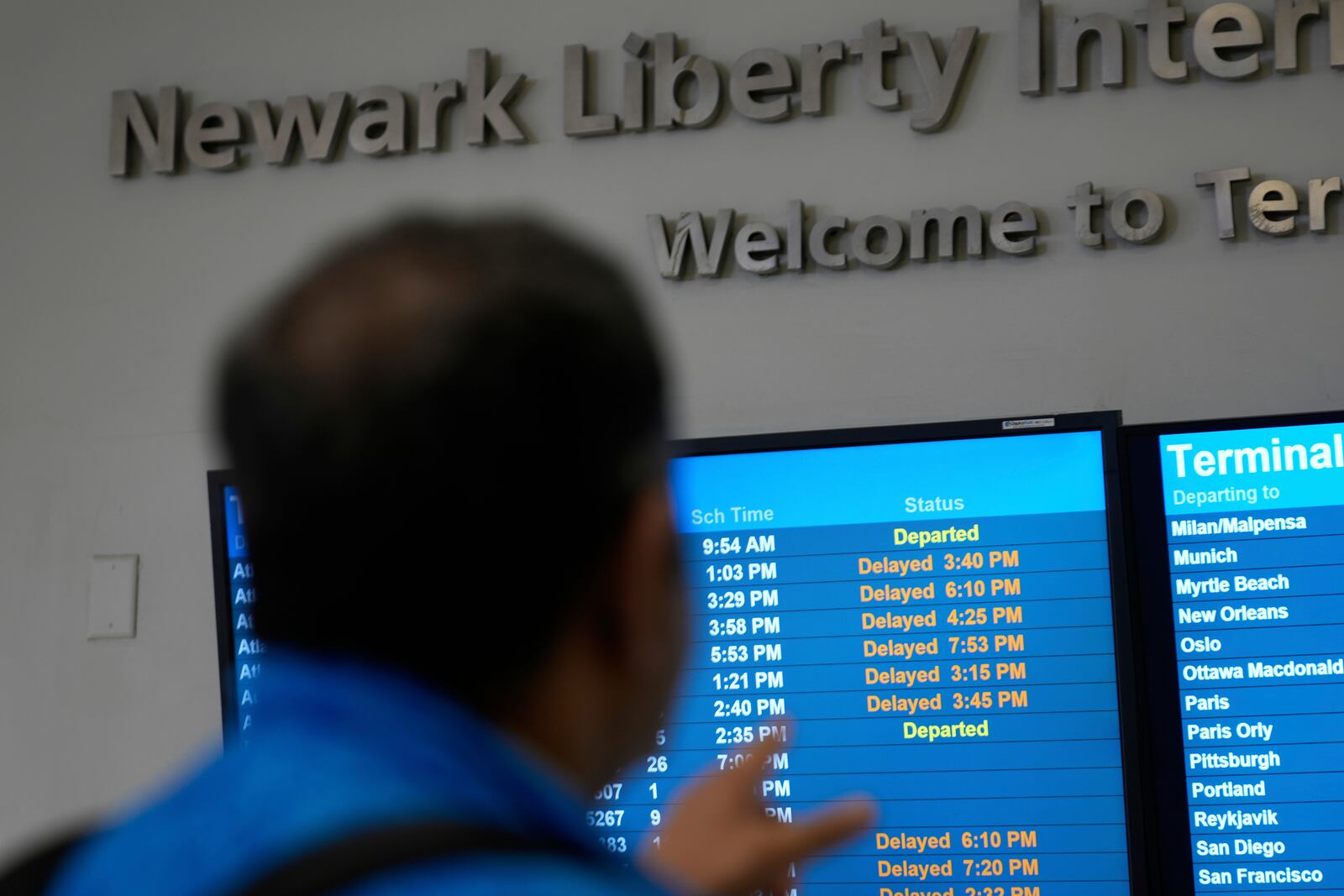 A display shows the status of flights at Newark Liberty International Airport in Newark, N.J., Monday, May 5, 2025. (AP Photo/Seth Wenig)