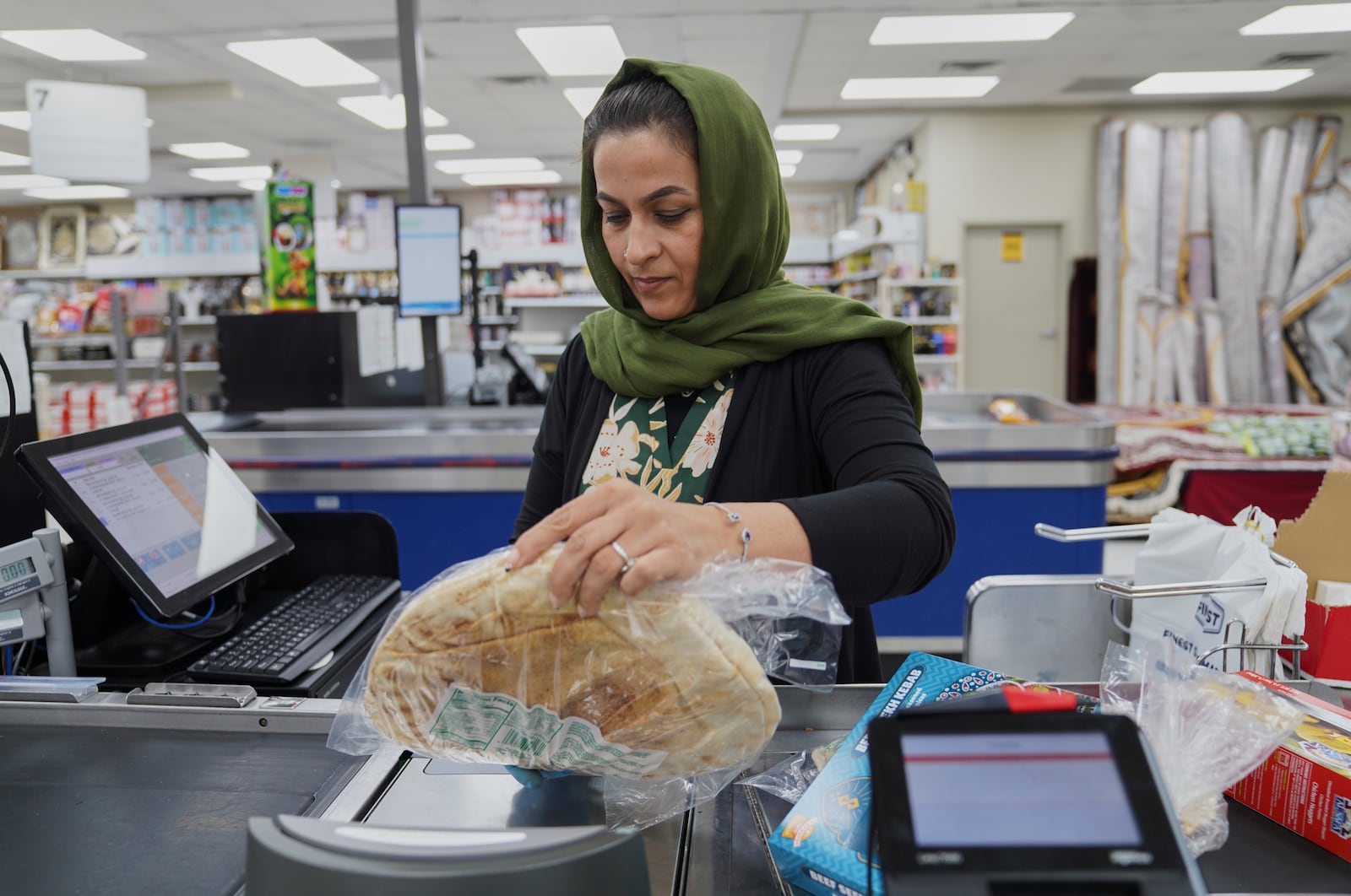 Locals shop at the Finest Supermarket halal grocery store in Fredericksburg, Va., on Monday, April 7, 2025. (AP Photo/Jessie Wardarski)