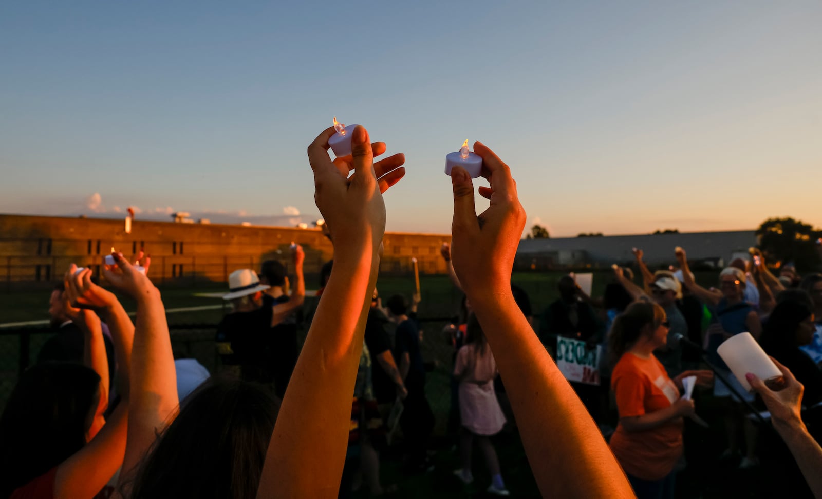 Over 100 faith leaders and advocates hold a candlelight vigil for Alonzo Tomas Mendez and other immigrants being held in Butler County Jail Tuesday, July 1, 2025 just outside the fence of the Butler County Sheriff's Office in Hamilton. NICK GRAHAM/STAFF