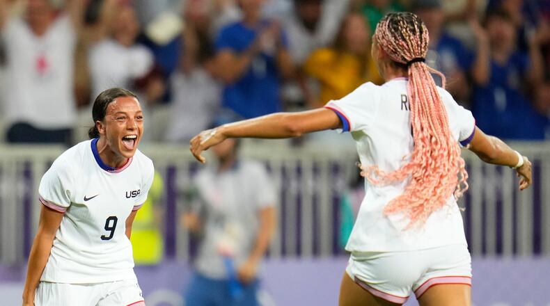 FILE - United States' Mallory Swanson, left, reacts after teammate Trinity Rodman, right, scored a goal during a women's group B match between the United States and Zambia at Nice Stadium at the 2024 Summer Olympics, July 25, 2024, in Nice, France. (AP Photo/Julio Cortez, File)