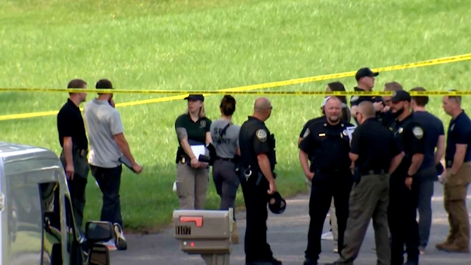 In this image taken from WSOC video, various police and officials gather outside a community after a mass shooting, Sunday, June 1, 2025, in Hickory, a city in Catawba County, N.C. (WSOC via AP)