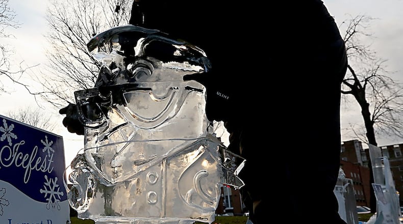 Greg Butauski, with Artic Diamond and the National Ice Carving Association’s 2014 Ice Carving Champion, set up an ice sculpture in front of the Historic Courthouse on Jan. 20, 2017, during IceFest in downtown Hamilton IceFest happens every two years. FILE