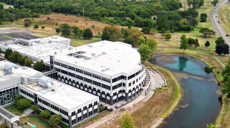 As part of Miami University's polytechnic initiative, the school is planning to develop a master plan for its Hamilton regional campus after it acquired nearly 55 acres. Pictured is the former Vora Tech building on Knightsbridge Drive which will house the new Advanced Manufacturing and Workforce Hub, a partnership with Butler Tech, the city of Hamilton, Hamilton City Schools and 30 businesses, among others. Miami University's southern campus is in the top right corner of this photo taken in August 2025. NICK GRAHAM/STAFF