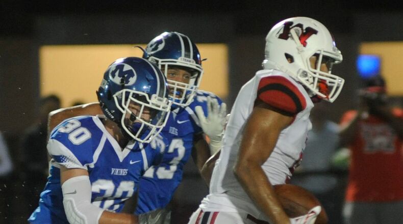 Wayne's L'Christian "Blue" Smith (with ball) beats Miamisburg's Tyler Grimes (30) and Tyler Johnson for a TD. Wayne defeated host Miamisburg 45-12 in a Week 4 high school football game on Friday, Sept. 16, 2016. MARC PENDLETON / STAFF
