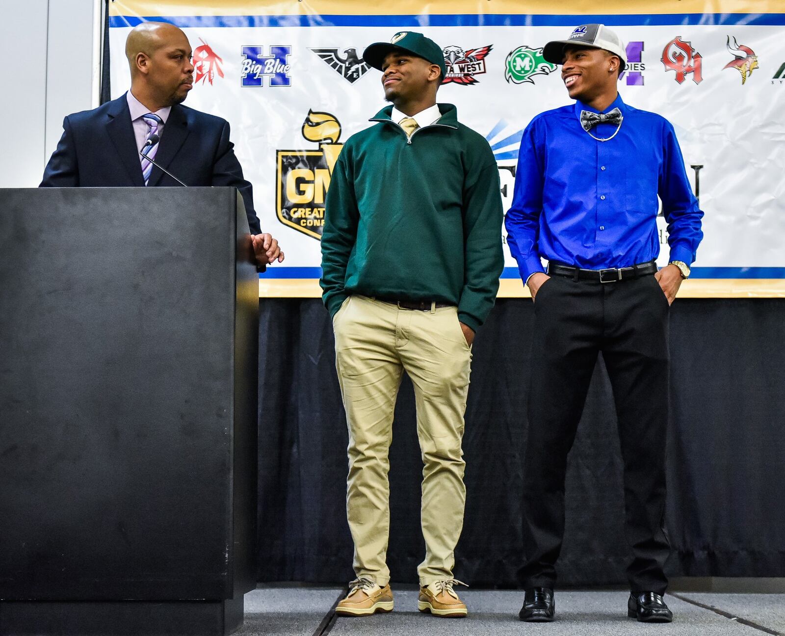 Middletown head football coach Don Simpson speaks about two Middie football players who have signed to play college football during the Greater Miami Conference National Signing Day event Wednesday at the Sharonville Convention Center. Shandon Morris (right) has committed to Notre Dame College, and Troy Vinson will attend Wayne State. NICK GRAHAM/STAFF
