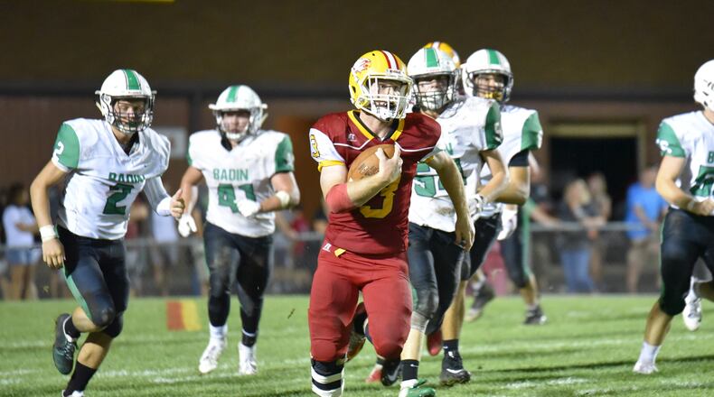 Fenwick’s Jack Fessler is chased by Badin’s Bobby Young (2), Ethan Wishart (41) and Evan Schlensker (54) during last Friday’s game at Krusling Field in Middletown Fenwick won 21-9. CONTRIBUTED PHOTO BY ANGIE MOHRHAUS
