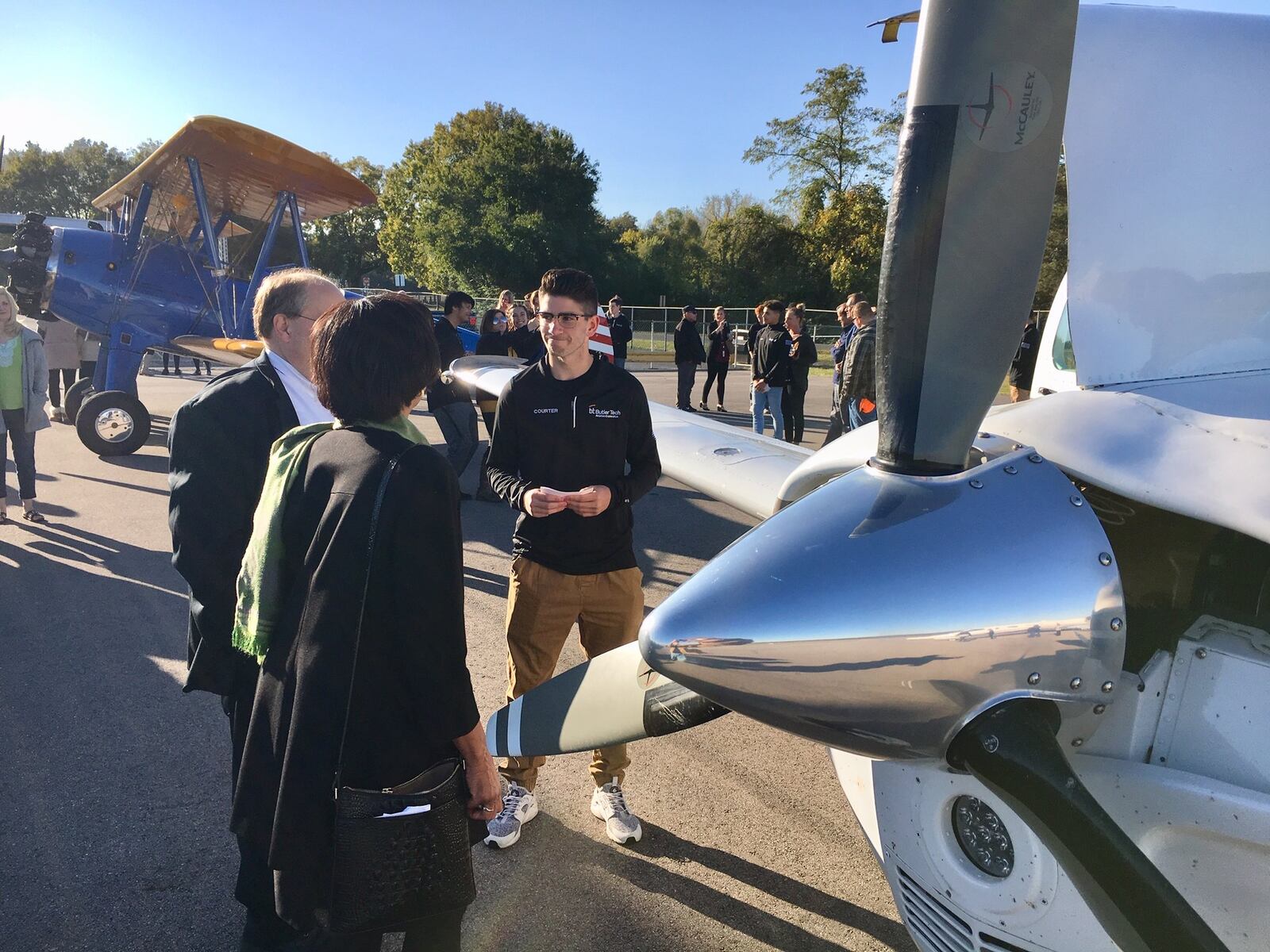Butler Tech and Middletown City officials publicly cut the opening ribbon on the career school’s new aviation careers program at the city’s airport Monday. The Aviation Exploration Program designed to train high school juniors and seniors in various aviation and drone flying career paths. Students - pictured here - then conducted tours of the new learning center and of the aircraft near the airport hangar, showing their knowledge of aviation history and aircraft development. (Photo by Michael D. Clark/Journal-News)