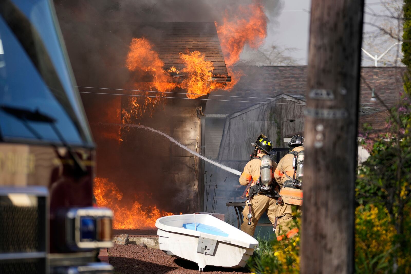 Firefighters battle a house fire Wednesday, April 23, 2025, in Lacey Township, N.J. (AP Photo/Matt Slocum)