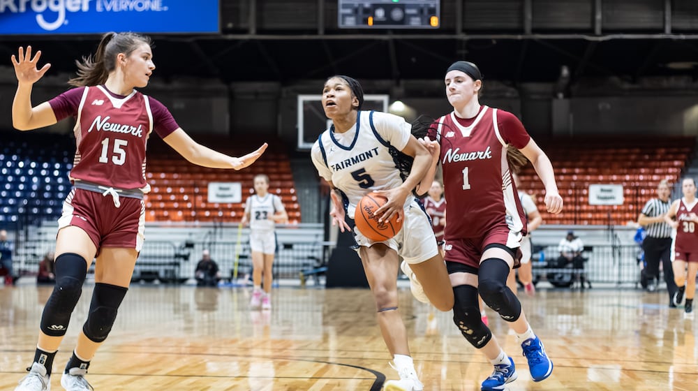 Fairmont High School senior Kaylah Thornton drives past Newark juniors Emma Quackenbush (1) and Calli Geller (15) during their Division I regional semifinal game on Tuesday, March 3 at the Ohio Expo Center's Taft Coliseum. MICHAEL COOPER / STAFF