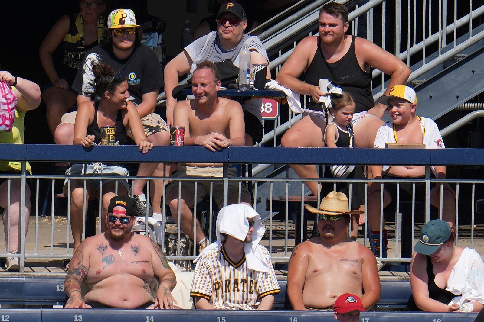 Extreme heat warnings didn't keep these fans from attending a baseball game between the Pittsburgh Pirates and the Texas Rangers in Pittsburgh, Sunday, June 22, 2025. (AP Photo/Gene J. Puskar)