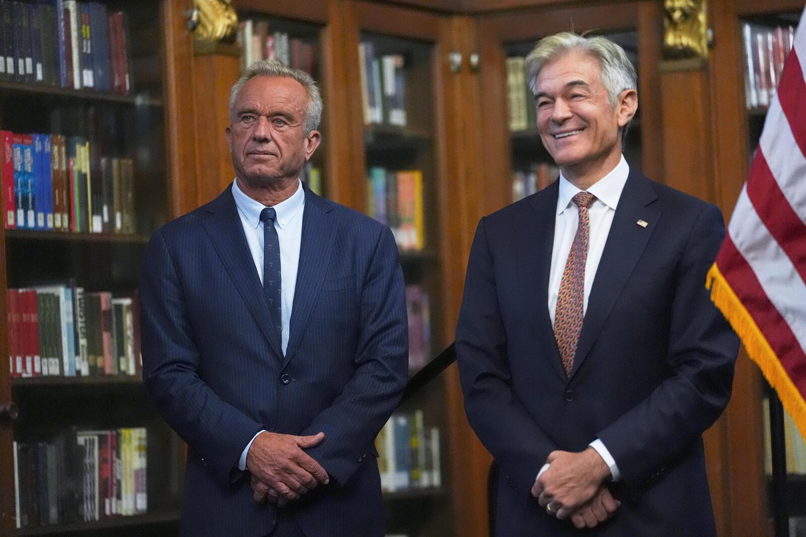 U.S. Health and Human Services Secretary Robert F. Kennedy, Jr., left, and Centers for Medicare and Medicaid Services Administrator Dr. Mehmet Oz listen during a Make Indiana Healthy Again initiative event in Indianapolis, Tuesday, April 15, 2025. (AP Photo/Michael Conroy)