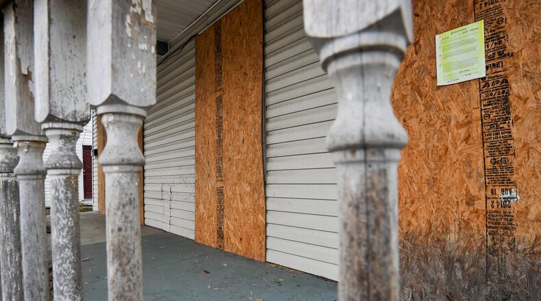 Lenders and property owners of vacant houses and buildings will not be able to use plywood to cover windows and doors, such as being used at this house at 209 Yankee Road. A new state law will now require windows and doors to be covered with a clear, transparent board to mask and stop the spread of housing abandonment. NICK GRAHAM/STAFF