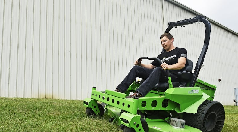 A Mean Green leader cuts grass with a demo unit outside the Mean Green Mowers facility in Ross Twp. in 2019. FILE