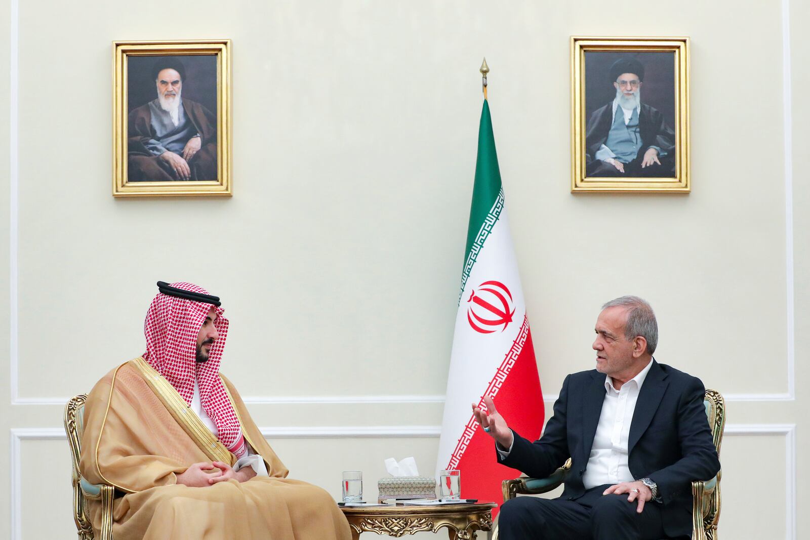 In this photo released by the Iranian Presidency Office, President Masoud Pezeshkian, right, speaks with Saudi Arabia's Defense Minister Prince Khalid bin Salman during their meeting, in Tehran, Iran, Thursday, April 17, 2025. (Iranian Presidency Office via AP)