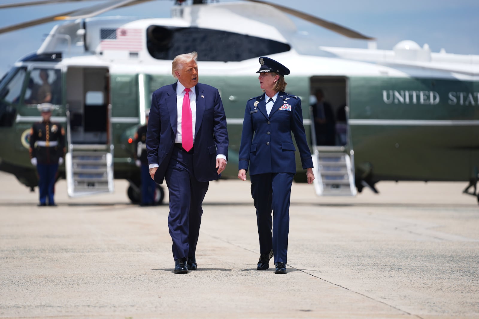 President Donald Trump, escorted by Air Force Col. Angela F. Ochoa, Commander, 89th Airlift Wing, speaks with reporters before boarding Air Force One, Tuesday, July 15, 2025, in Joint Base Andrews, Md. (AP Photo/Evan Vucci)