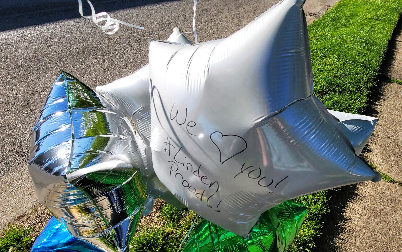 A memorial is growing on Pleasant Avenue in Hamilton's Lindenwald neighborhood where a 6-year-old boy was struck by a car and killed Tuesday night. NICK GRAHAM/STAFF