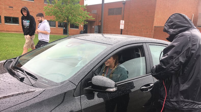 Bailey Burris, 17, a junior at Lakota East High School, has her car inspected Friday by automotive technicians. Technicians then discussed any detected problem with each student and provided an inspection sheet to take home to parents, said Kellie O Riordan, AAA traffic safety program manager. RICK McCRABB/STAFF