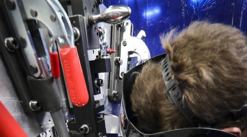 Sinclair College is bringing back its welding program for the first time in 20 years. Pictured is a Unison welder, at work at the company’s Beavercreek plant. CONTRIBUTED