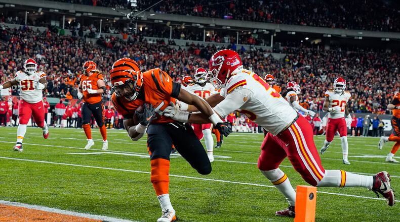 File - Cincinnati Bengals running back Chris Evans (25) runs in for a touchdown past Kansas City Chiefs defensive end George Karlaftis (56) in the second half of an NFL football game in Cincinnati, Fla., Sunday, Dec. 4, 2022. (AP Photo/Jeff Dean)