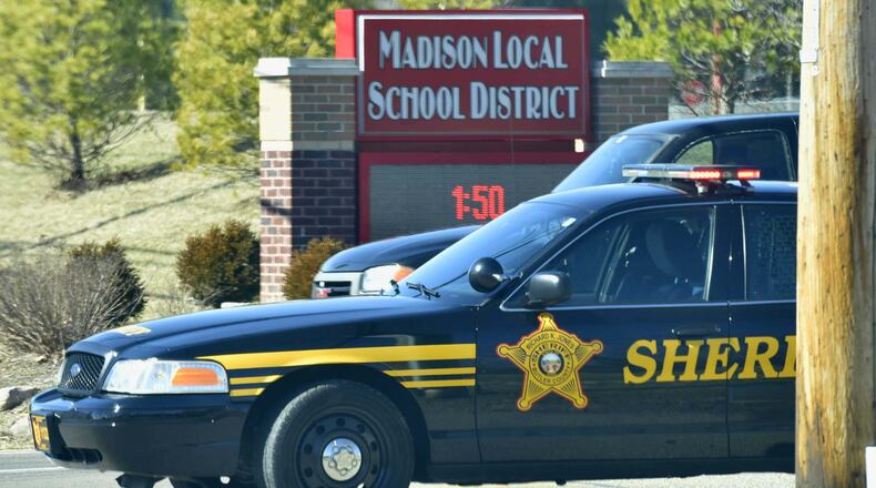 The Ohio Supreme Court heard the case about the Madison Local Schools armed staff policy on Jan. 12, 2021. Butler County sheriffs deputies block the entrance to Madison Jr./Sr. High School after a shooting in 2016. STAFF FILE/2016