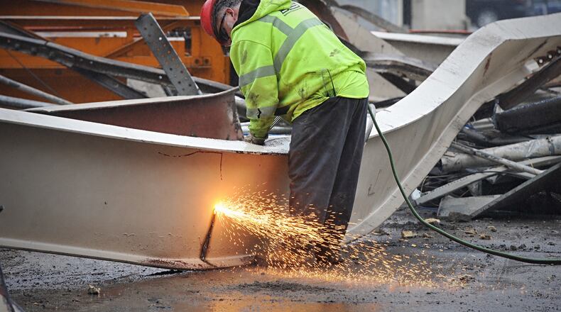 A worker at work on a downtown project to build a hotel near Day Air Field.