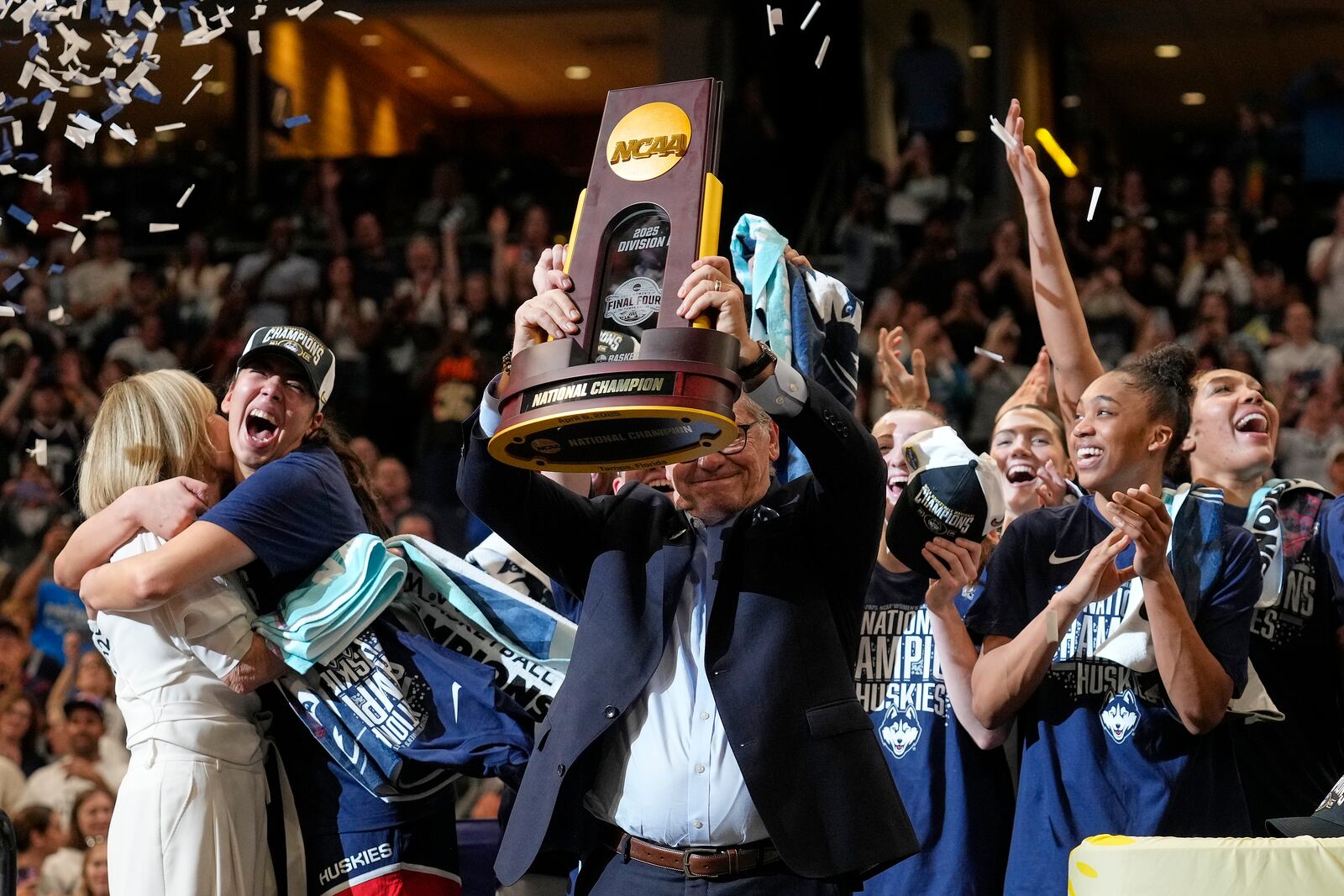 UConn head coach Geno Auriemma holds up the championship trophy after UConn defeated South Carolina in the national championship game at the Final Four of the women's NCAA college basketball tournament, Sunday, April 6, 2025, in Tampa, Fla. (AP Photo/Chris O'Meara)