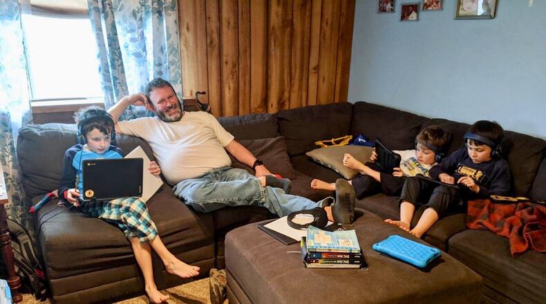 It’s shoes and socks optional learning at home for the Farler family and thousands of other area school families who are staying home under preventive measures to bind the spread of the Coronavirus. The Talawanda family say the subsequent togetherness has many benefits - here Andy Farler oversees his children’s digital learning and activities - and a few challenges. (Provided Photo/Journal-News)