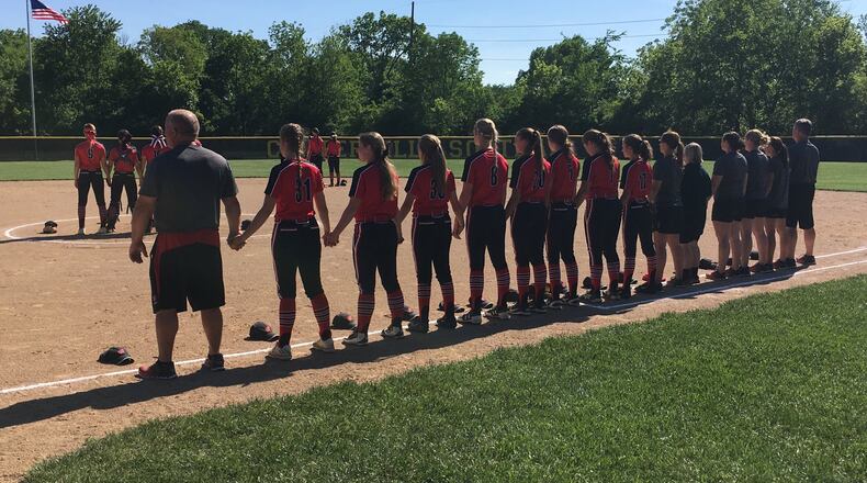 Lakota West’s players and coaches stand together during the National Anthem at last Wednesday’s Division I regional semifinal against Mason at Centerville. RICK CASSANO/STAFF