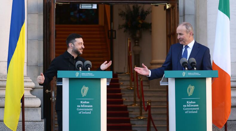 Ukraine's President Volodymyr Zelenskyy, left, and the Irish Prime Minister Micheal Martin gesture to each other as they take part in a joint press conference in Dublin, Ireland, Tuesday, Dec. 2, 2025. (AP Photo/Peter Morrison)