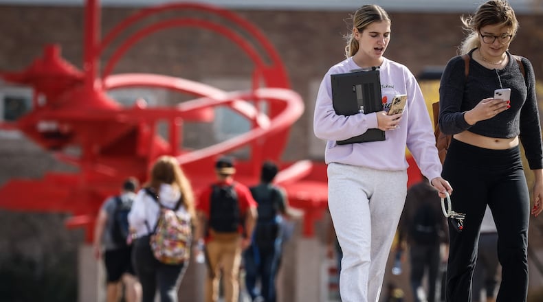 Students at Wright State University walk to and from class at the university. Wright State has the second-least expensive sticker price for tuition among public Ohio universities this year. JIM NOELKER/STAFF