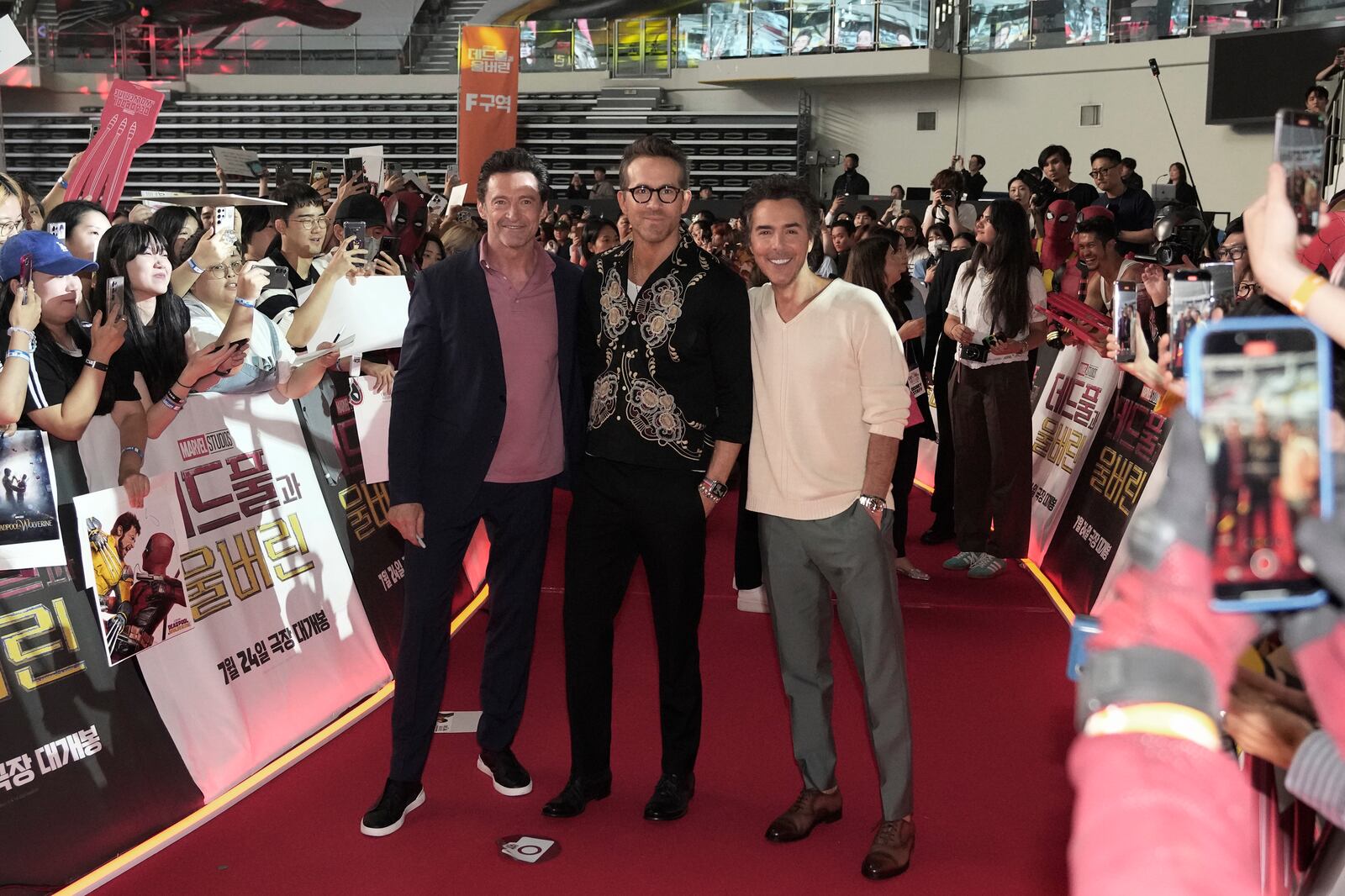 FILE - Actor Hugh Jackman, left, Ryan Reynolds and director Shawn Levy, right, pose during the red carpet event to promote their latest movie "Deadpool & Wolverine" in Seoul, South Korea, July 4, 2024. (AP Photo/Ahn young-joon, File)