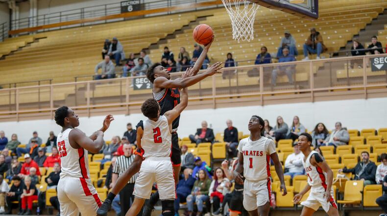 Beavercreek High School senior Mali Harris-Strayhorn shoots a layup in a crowd of West Carrollton defenders during their game on Wednesday night at the Vandalia Butler Student Activity Center. The Beavers won 64-63. CONTRIBUTED PHOTO BY MICHAEL COOPER