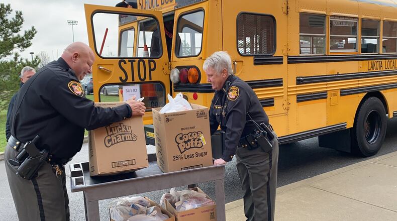 School resource officers from the Butler County Sheriff’s Office are helping out with the Lakota school district child nutrition department preparing and distributing meals during the coronavirus pandemic. SUBMITTED