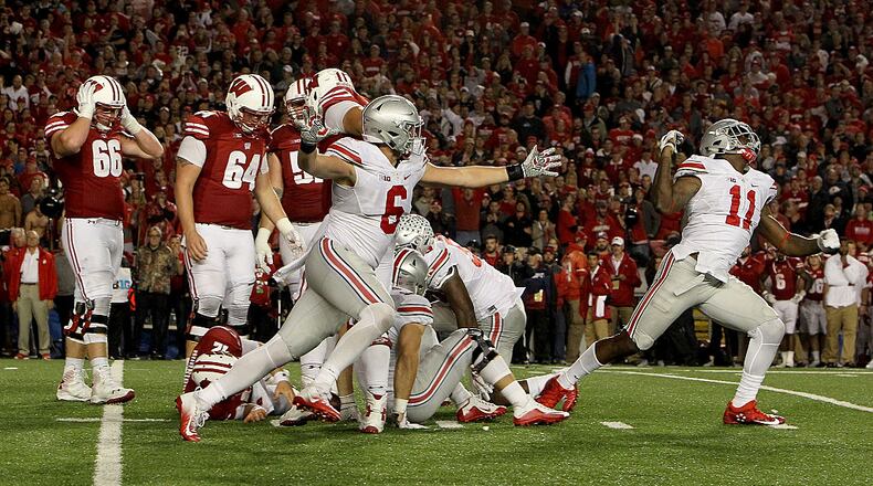 MADISON, WI - OCTOBER 15: The Ohio State Buckeyes celebrate after sacking Alex Hornibrook #12 of the Wisconsin Badgers to end the game in overtime at Camp Randall Stadium on October 15, 2016 in Madison, Wisconsin. (Photo by Dylan Buell/Getty Images)