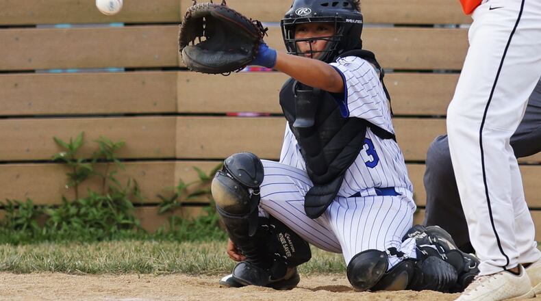 Hamilton's Sammy Platt catches the ball behind the plate during Hamilton West Side Little League's 10-1 win over Loveland in the District 9 Little League championship Monday, July 11, 2022 at Home of the Brave Park in Loveland. NICK GRAHAM/STAFF