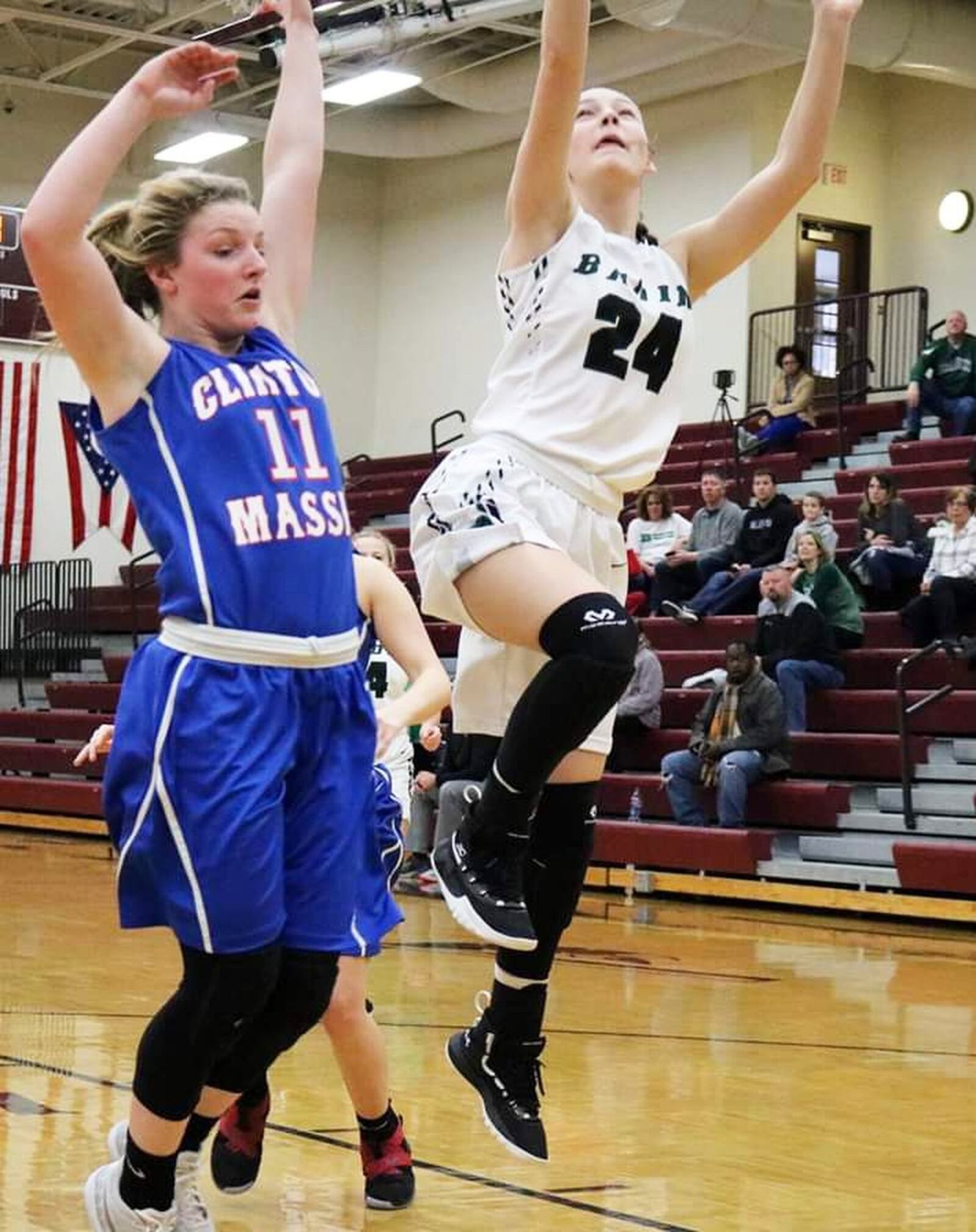 Badin’s Laney Cosgrove (24) goes to the basket as Clinton-Massie’s Natalie Lay (11) defends Saturday afternoon during a Division II sectional opener at Lebanon. Badin won 54-10. CONTRIBUTED PHOTO BY TERRI ADAMS