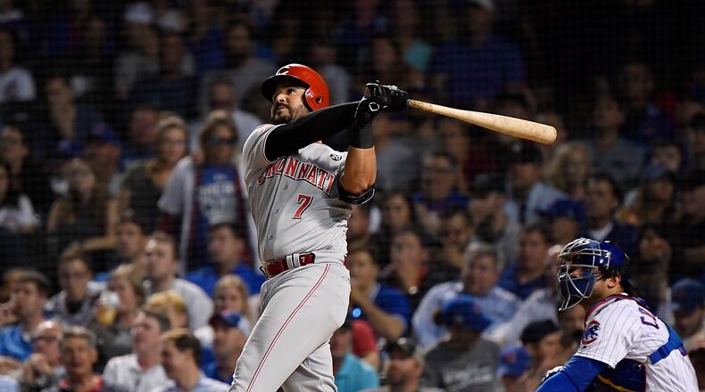 CHICAGO, ILLINOIS - SEPTEMBER 18: Eugenio Suarez #7 of the Cincinnati Reds hits a home run in the fourth inning against the Chicago Cubs at Wrigley Field on September 18, 2019 in Chicago, Illinois. (Photo by Quinn Harris/Getty Images)