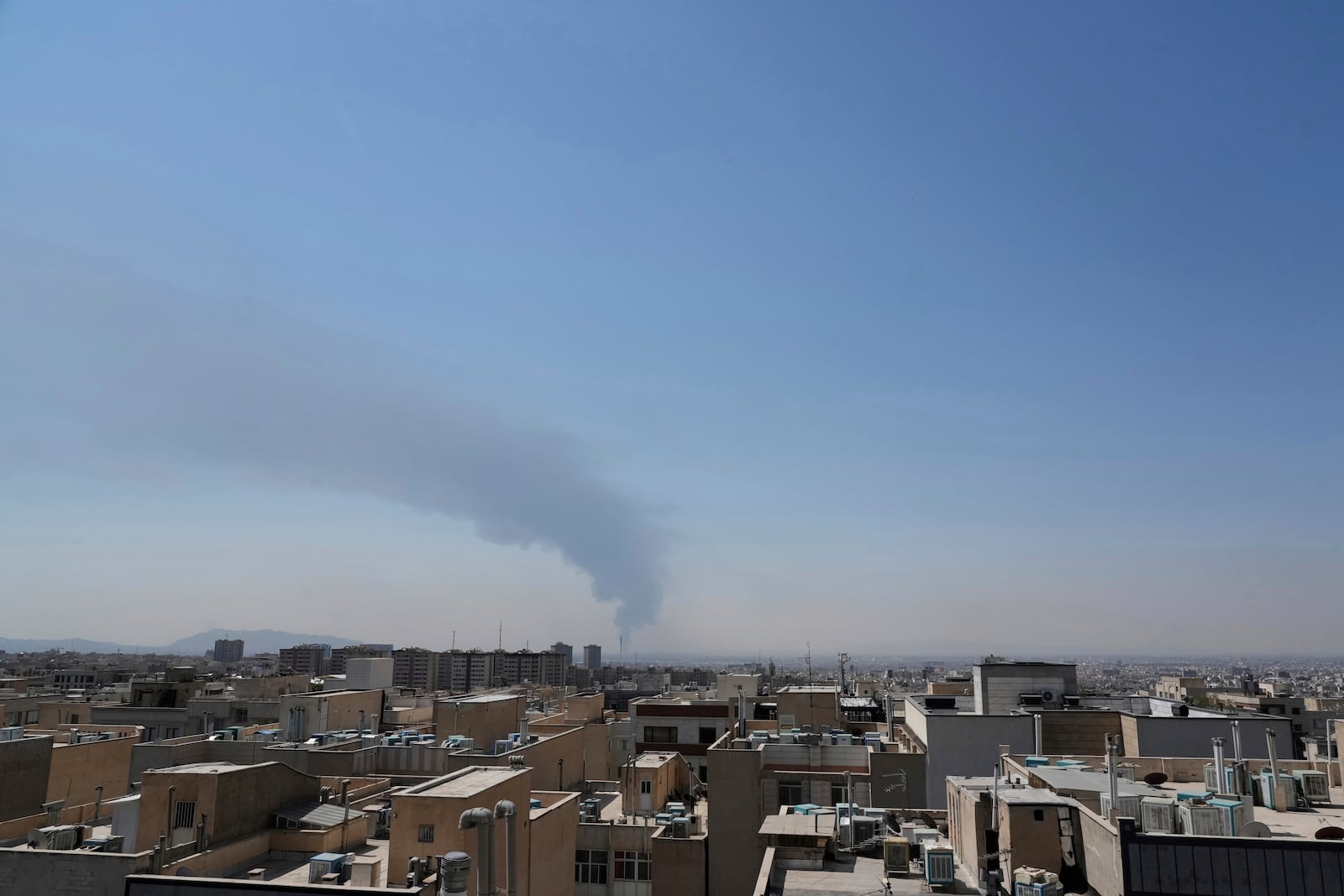 Huge smoke rises up from an oil facility after a Saturday explosion in southern Tehran, Iran, Sunday, June 15, 2025. (AP Photo/Vahid Salemi)