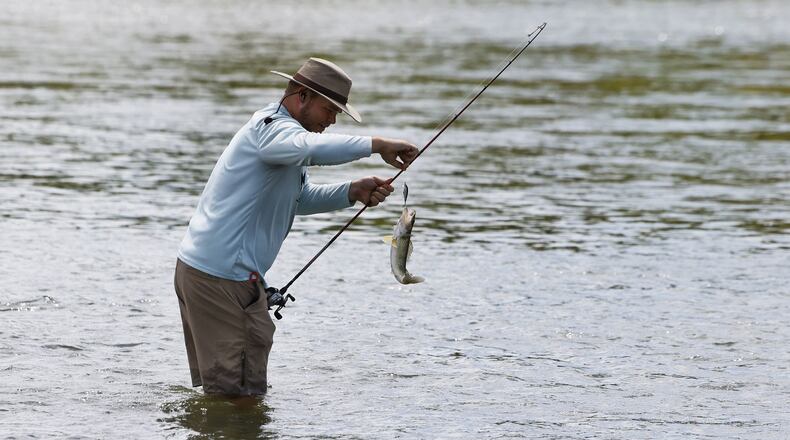 David Monnin catches a saugeye fishing in the the Great Miami River Thursday, July 13, 2023 in Hamilton. NICK GRAHAM/STAFF