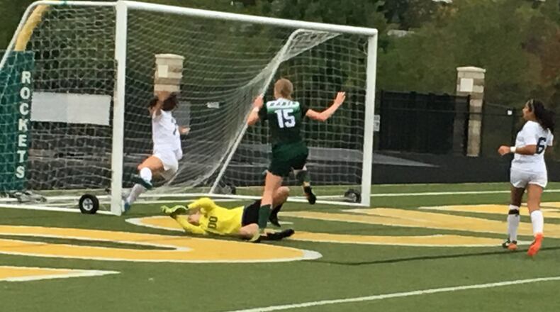 Badin’s Gabi Reising (15) has her scoring attempt denied by goalkeeper Maddie Kouche and Claire Dotson (7) of McNicholas as the Rockets’ Maria Randolph (6) trails the play Wednesday night at Penn Station Stadium in Cincinnati. RICK CASSANO/STAFF