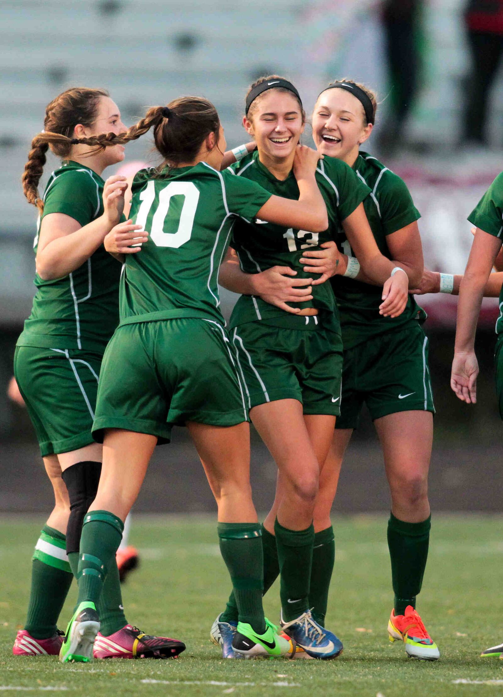 Malia Berkely (13) is mobbed by her teammates after scoring the winning goal in the first half of Saturday's Division III Regional Final match against Lehman at Atrium Field in Lebanon Nov. 2, 2013. NICK DAGGY / STAFF