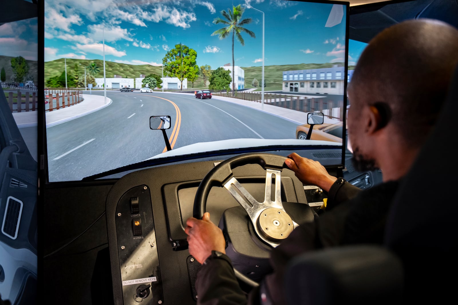Mohammed Kamal practices handling a tractor-trailer truck in a driving simulator at the Driving Academy on Tuesday, June 10, 2025 in Linden, N.J. (AP Photo/Angelina Katsanis)