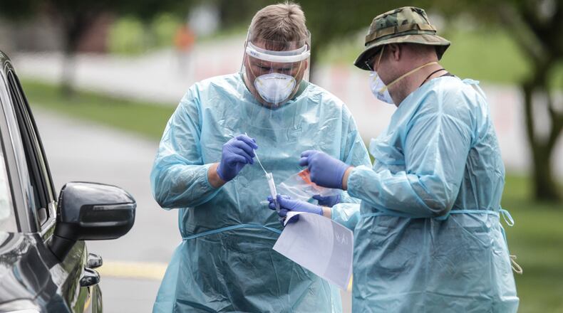 Members of Montgomery County Public Health and the Ohio National Guard help with pop-up testing Tuesday at Kettering Fields, 444 North Bend Blvd. Results from the latest coronavirus pop-up testing site are expected in a more timely manner and results are accessible online to patients, following a switch to a new laboratory. JIM NOELKER/STAFF