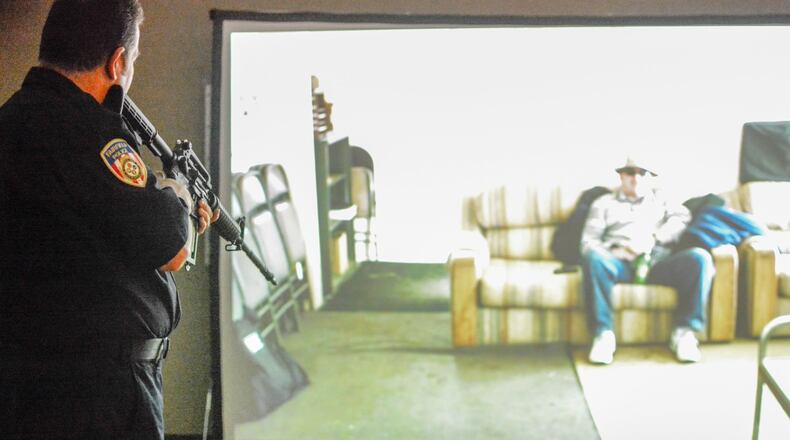 The city of Fairfield has agreed to purchase a training simulator to help officers make split-second decisions in high-pressure scenarios. Pictured is Fairfield Police Officer Doug Day testing one of the vendors the city considered in April 2017. MICHAEL D. PITMAN/STAFF