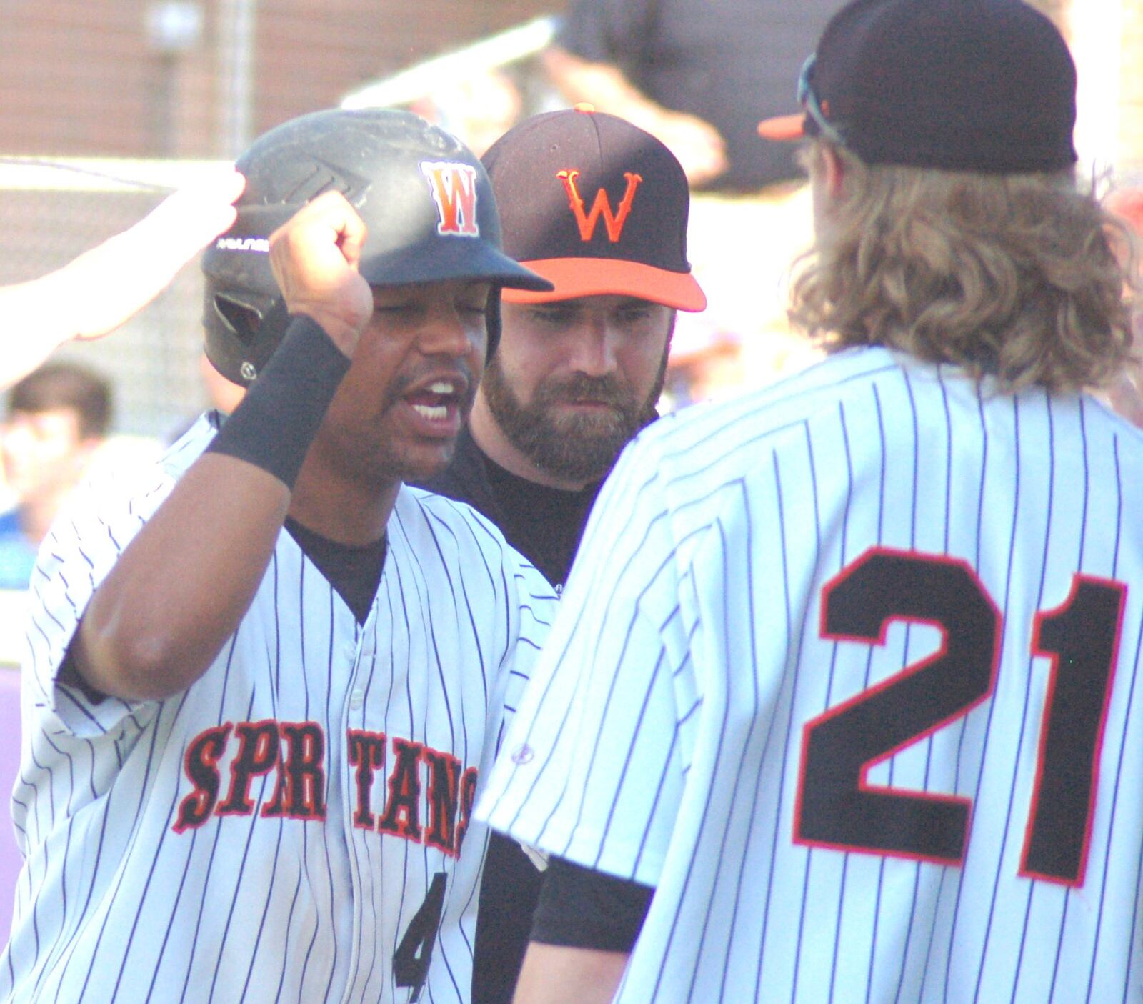 Waynesville’s Hunt Doepel is greeted at the dugout after scoring a run in the second inning Thursday during a Division II sectional final against Madison at Eaton. CONTRIBUTED PHOTO BY JOHN CUMMINGS