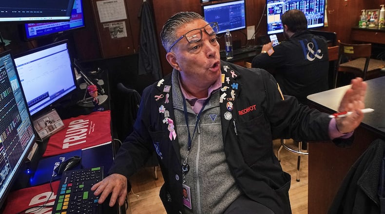 Trader Jonathan Mueller works on the floor of the New York Stock Exchange, Thursday, Dec. 11, 2025. (AP Photo/Richard Drew)