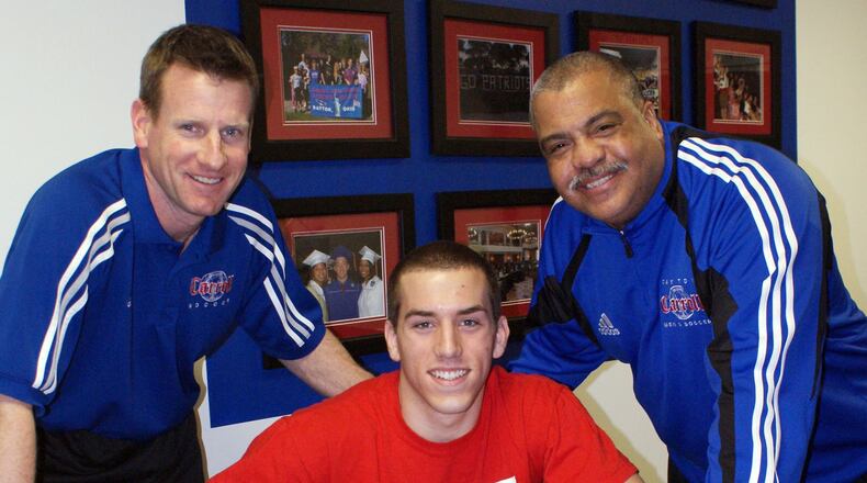 Carroll High School soccer All-American Jon Buschur signed a National Letter of Intent to continue his career at the University of Dayton in 2010. Joining Jon on Signing Day were Carroll coach Scott Molfenter (left) and assistant coach Daryl Jones. FILE PHOTO