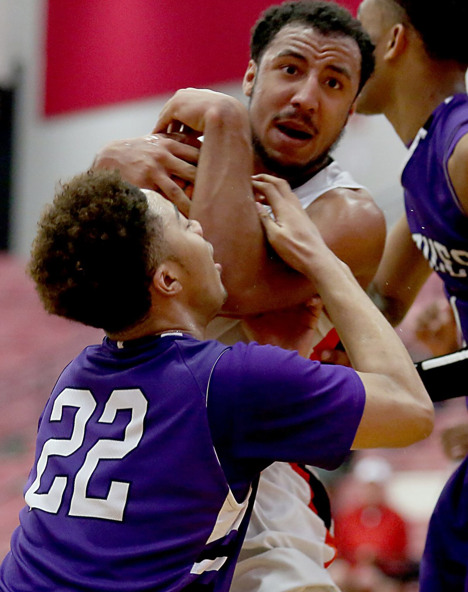 Wilmington guard Dylan Beaugard hangs on to a rebound as Middletown forward Christian Strother tries to make the steal during their Division I sectional game at Fairfield Arena on Tuesday night. CONTRIBUTED PHOTO BY E.L. HUBBARD