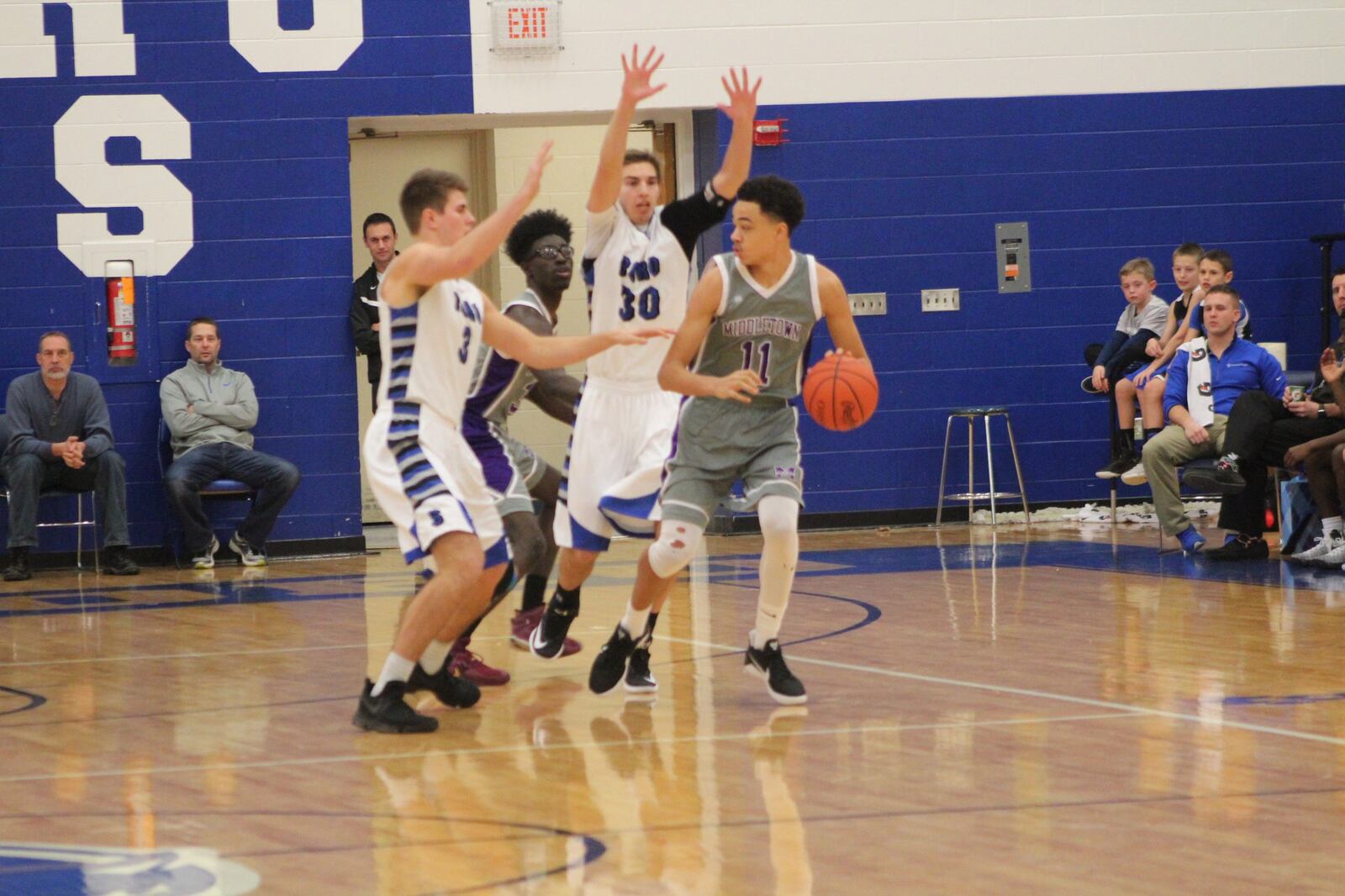 Middletown’s Cliff Snow (11) is guarded by Springboro’s Nick Pluta (3) and Trey Varinsky (30) during Saturday night’s game at Springboro. CONTRIBUTED PHOTO BY MARITZA MCKINNEY