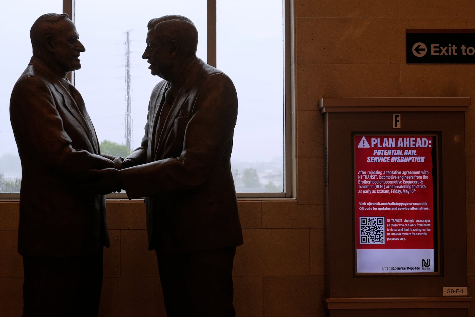 An electronic display advises commuters of potential NJ Transit service disruptions at the Secaucus Junction station in Secaucus, N.J., Wednesday, May 14, 2025. (AP Photo/Seth Wenig)
